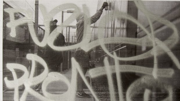 A tagger tags the exhibition of grafitti.