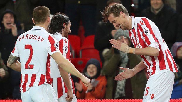 Stoke City's Peter Crouch, right, celebrates goalNo.100.