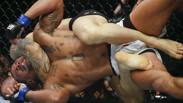 Mindless savagery: Gleison Tibau, of Brazil, puts American Abel Trujillo in a choke-hold during a recent UFC bout.
