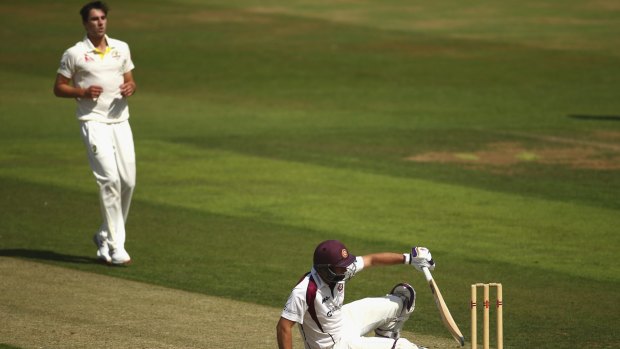 Bouncer beware: Pat Cummins sits county batsman David Murphy on the pitch 