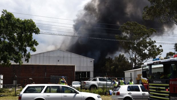 Thick black smoke fills the sky as a blaze burns in south-west Sydney.
