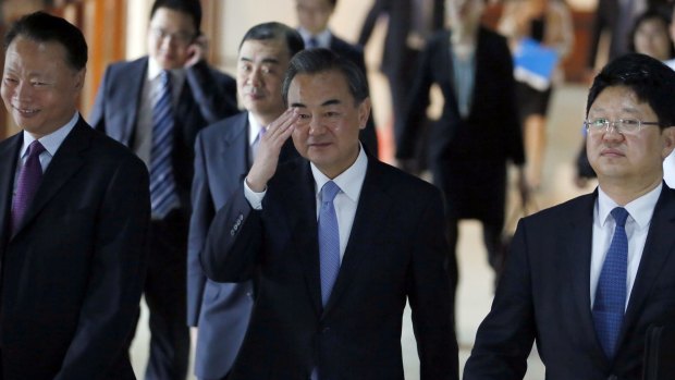 Chinese Foreign Minster Wang Yi, centre, waves to the media while on a visit to the Philippines this month.