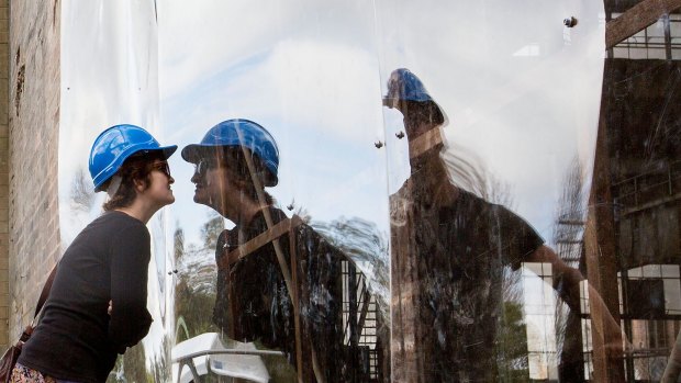 Visitors peer though perspex windows to see inside White Bay power station during an open day.
