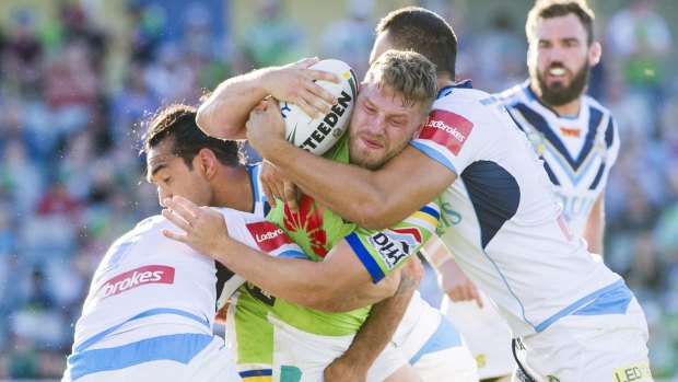 Tough going: Five-eighth Elliot Whitehead hits the Titans defence.