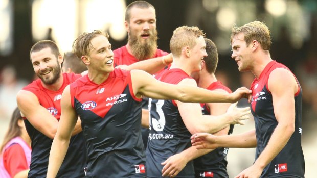 All smiles: The Demons celebrate a Tomas Bugg goal
