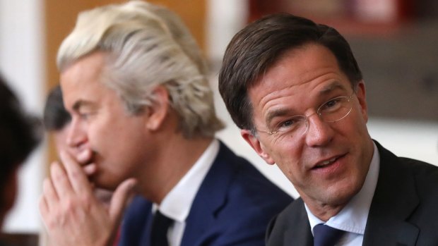 Dutch Prime Minister Mark Rutte sits next to Geert Wilders.