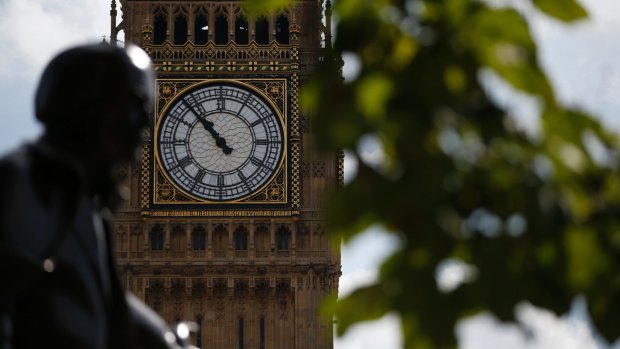 The statue of former British Prime Minister David Lloyd George is silhouetted against the Queen Elizabeth Tower which holds the bell known as 'Big Ben' in London.