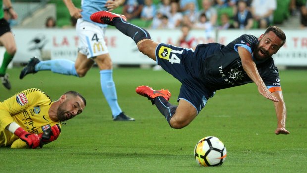 Tumble: Alex Brosque is brought down by goalkeeper Dean Bouzanis to earn the penalty that resulted in Sydney FC opening the scoring.
