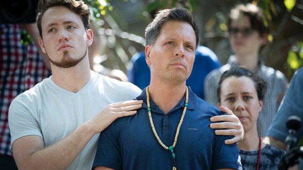 Don Damond is comforted by his son Zach Damond following the death of his fiancee Justine.