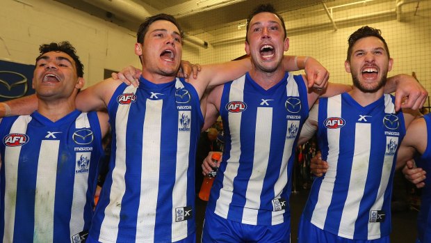 Back then: Kangaroos Lindsay Thomas, Nathan Grima, Todd Goldstein and Aaron Black sing the song after winning their semi-final against Geelong in 2014.
