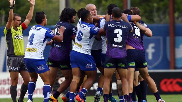 Difference of opinion: The Canterbury Bulldogs and the Melbourne Storm exchange blows at Belmore Sports Ground on Saturday.
