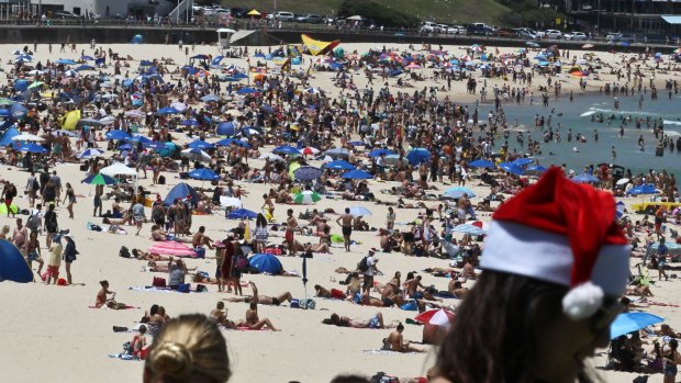 People flock to Bondi Beach to enjoy the great weather on Christmas Day.