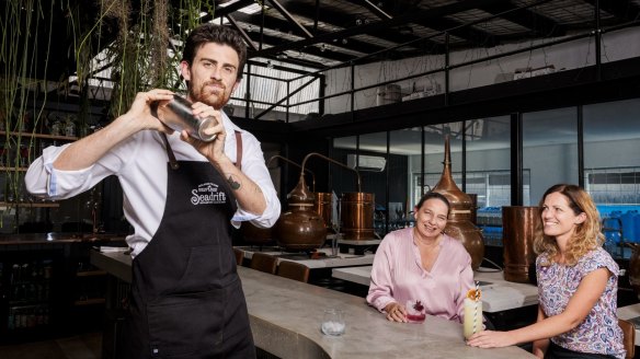 Lachie serves up alcohol-free cocktails to Kate and Carolyn at Seadrift Distillery in Brookvale, which distills non-alcoholic spirits.