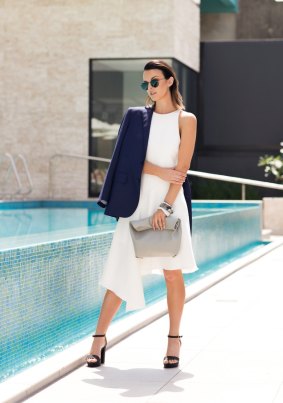 Brisbane blogger Manda Wilde balances an oversized coat with a sleek, figure-hugging knit dress. Her clutch has no embellishments yet is intriguing thanks to its fluid look.