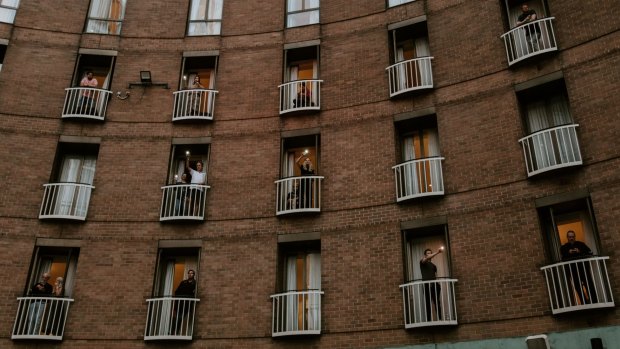 Guests on their balconies at the Sofitel Sydney Wentworth during a concert held for them in April last year.