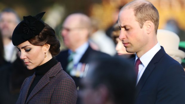 The Duke and Duchess of Cambridge bow their heads during the Gallipoli service at the Sandringham war memorial on Sunday. 