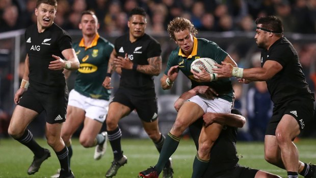 Black wall: Andre Coetzee is challenged by Kane Hames.