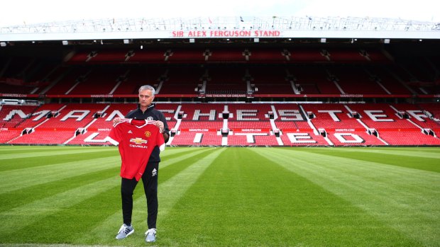 New Manchester United manager Jose Mourinho stands in front of the Sir Alex Ferguson Stand at Old Trafford on Wednesday.