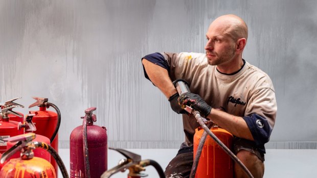 Ash Keating uses paint-filled fire extinguishers to create his giant works.