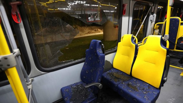 Shattered glass lies on the seats of the media bus.