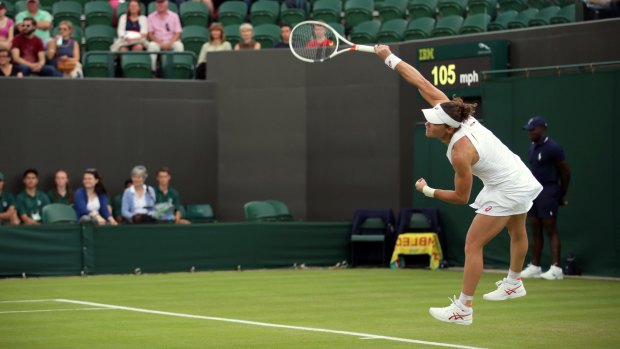 Strong display: Samantha Stosur serves during the first round at Wimbledon.