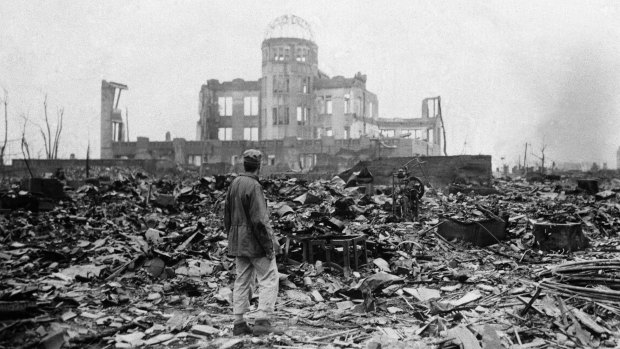 An Allied correspondent stands in the rubble of a building that once was a movie theatre in Hiroshima, on Sepember 8, 1945, two days after the first nuclear weapon ever used in warfare was dropped by the US.