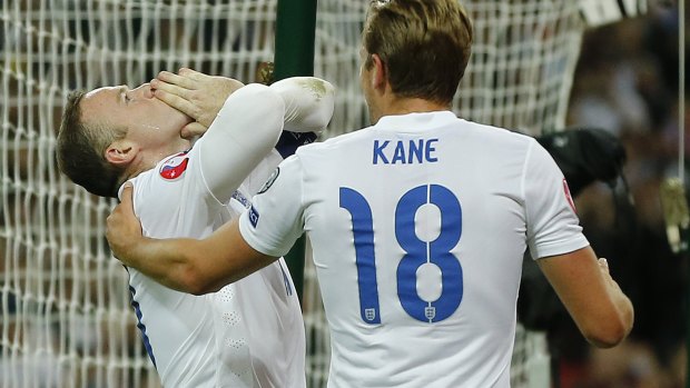 Number one with a bullet: Wayne Rooney celebrates with Harry Kane.