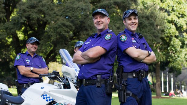 Senior Constable Craig Parkinson, Senior Constable Andrew Hodgson, and Constable Jarryd De Castro wear purple in Hyde Park to celebrate Wear It Purple Day.