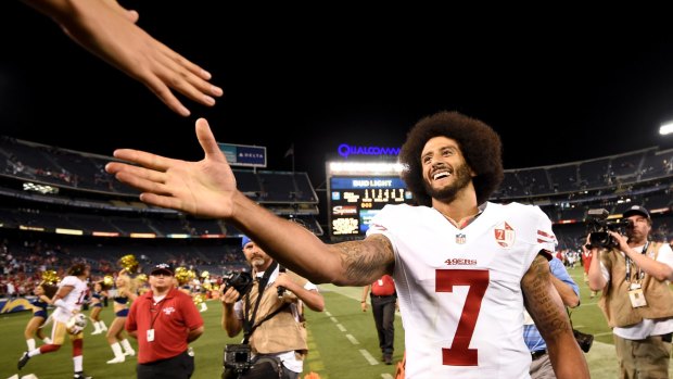 Polarising figure: San Francisco 49ers quarterback Colin Kaepernick shakes hands with fans after the 49ers defeated the San Diego Chargers 31-21 during an NFL preseason game on Thursday.