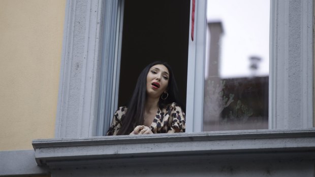 Italian opera singer Laura Baldassari sings from her window in Milan during the lockdown.