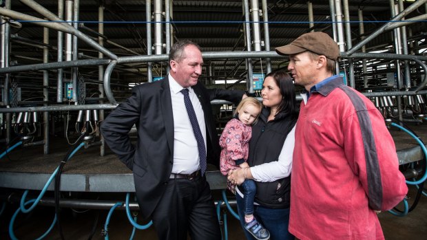 Barnaby Joyce talks with dairy farmer Ashley Galt and his wife Lucy Galt. 