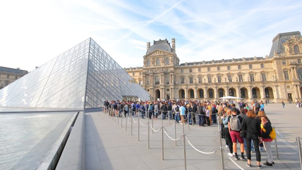 Visitors queue to enter the Louvre museum in Paris. France is the world's most-visited country this year. 