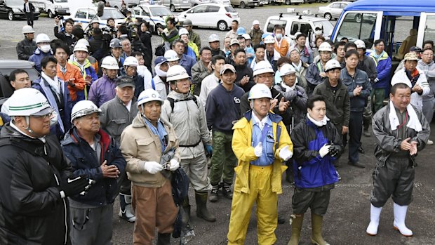 Rescuers celebrate after the missing boy was found.