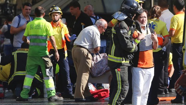 Injured people are treated in Barcelona, Spain, after the vehicle attack.