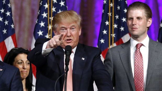 Donald Trump and his son Eric (right) speak to supporters at his Mar-a-Lago Club in Palm Beach.