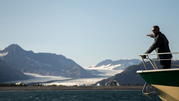 Mr Obama looks at Bear Glacier while on a boat tour in Resurrection Cove, Alaska.  