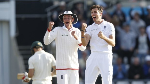 England's Steven Finn and Stuart Broad celebrate the wicket of Mitchell Johnson.
