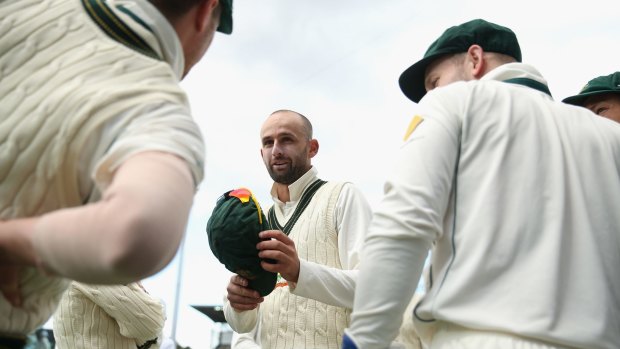 In the money: Nathan Lyon talks to teammates during the first Test match against the West Indies.