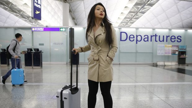 Canada's Miss World contestant Anastasia Lin poses for photographers after she was denied entry to mainland China, at Hong Kong International Airport.