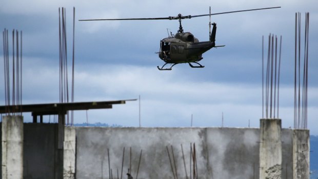 A military helicopter prepares to land as fighting continues in Marawi on Friday.