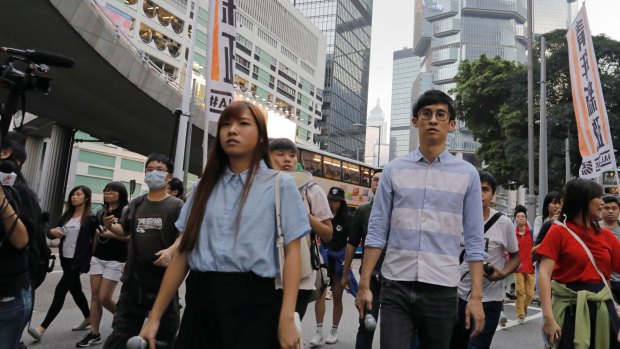 Newly elected Hong Kong lawmakers Yau Wai-ching, left, and Sixtus Leung, march along with thousands of people through downtown Hong Kong last month.