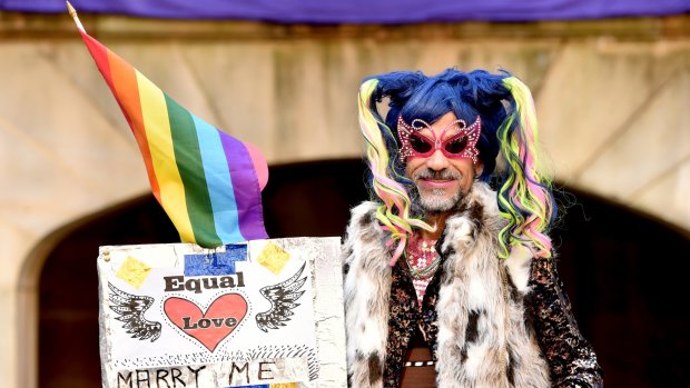 'Love is an awful thing to hate': A supporter of marriage equality at the Sydney rally.
