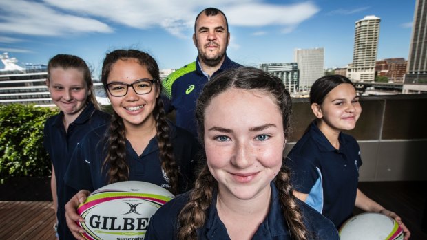 Wallabies coach Michael Cheika with girls from St Clare's High School, Emily Broquet-Mouledous, Kylie Gallagher, Niamh McGivney and Eliza Abdul.