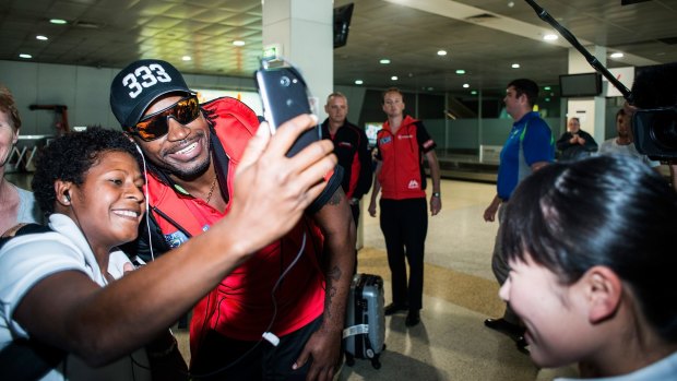Selfie time: Chris Gayle arrives at Tullamarine Airport on Tuesday after creating a firestorm in Hobart the previous night.