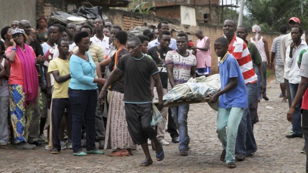 A victim of Friday's violence is stretchered away in the Nyakabiga neighbourhood of Bujumbura.