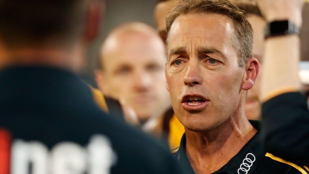 Alastair Clarkson speaks with his players at the MCG.