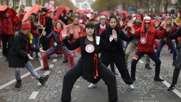 Climate activists perform during a  demonstration in Paris.