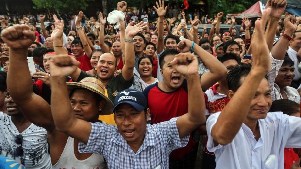 National League for Democracy party supporters cheer as they gather to hear first election results outside the party headquarters, in Yangon, on Sunday.