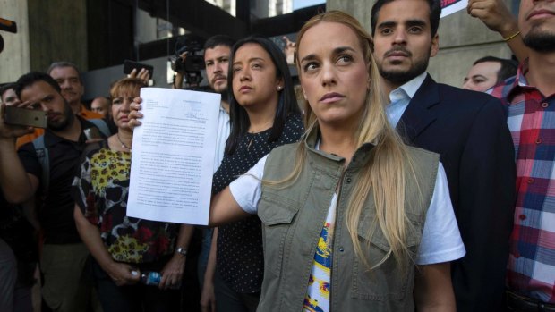 Lilian Tintori, left, wife of jailed opposition leader Leopoldo Lopez, holds documents outside of the Ombudsman's offices in Caracas, Venezuela.