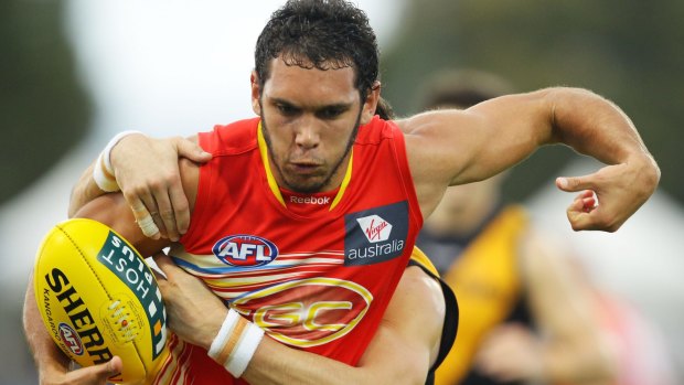 Being pursued: Harley Bennell of the Gold Coast Suns.